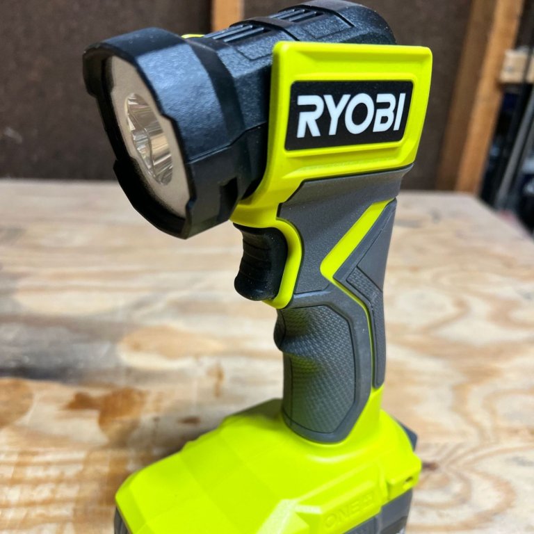 Ryobi flashlight on a workbench during testing