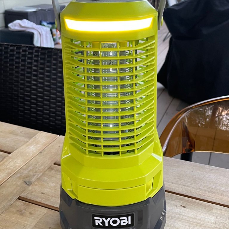 The Ryobi ONE+ Cordless Bug Zapper light and handle on an outdoor table during testing