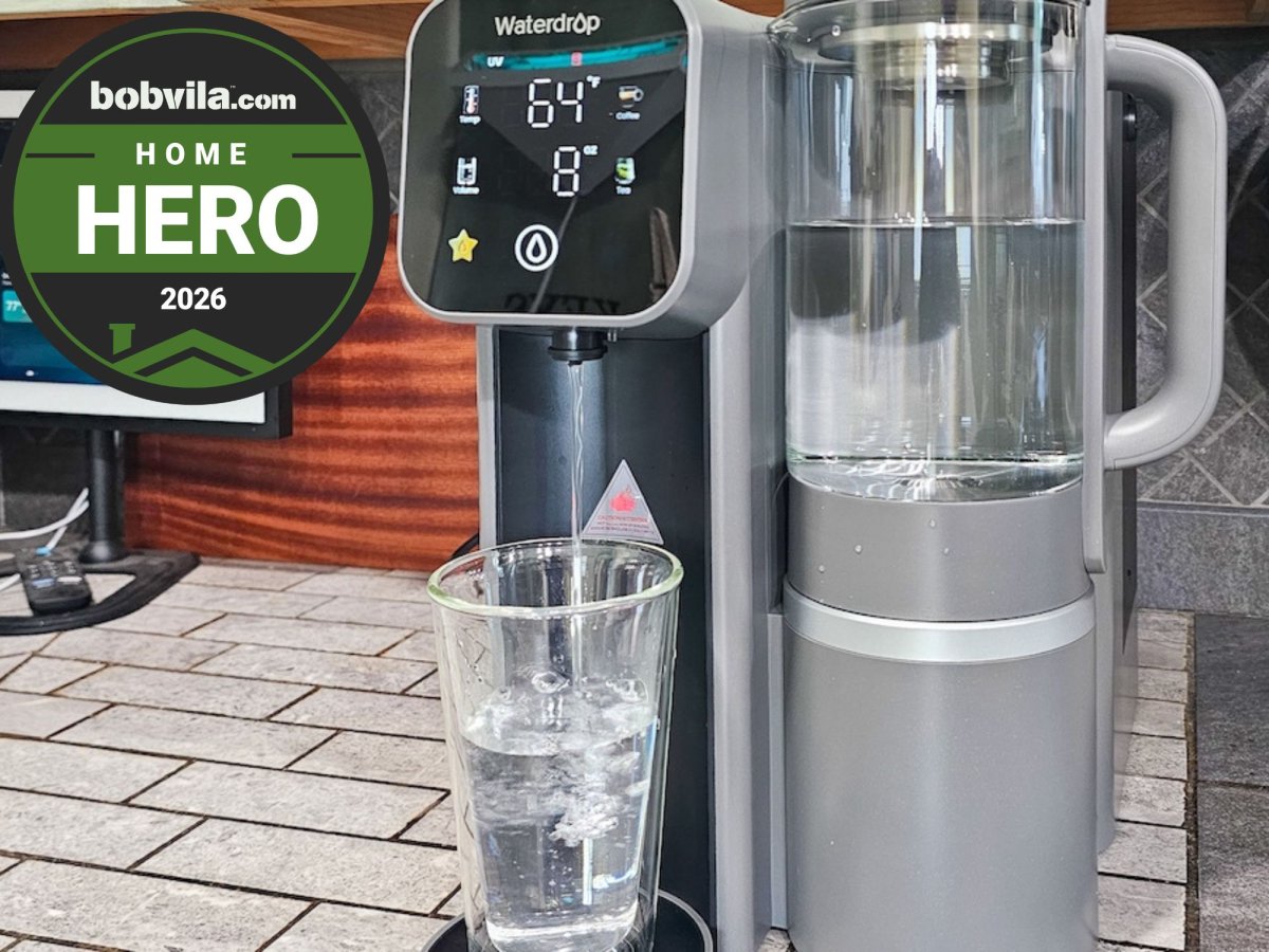 The Waterdrop M6H on a countertop filling a glass of drinking water during testing