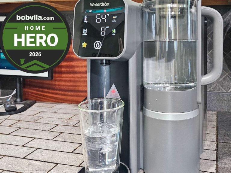 The Waterdrop M6H on a countertop filling a glass of drinking water during testing