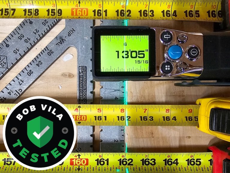 The Mileseey XTape 1 on a workbench with a variety of measuring tools around it