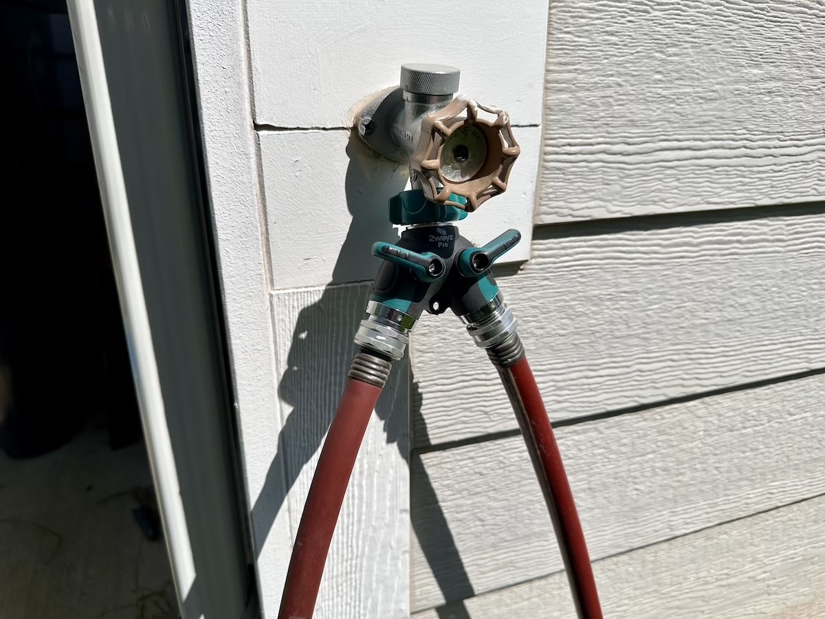 The 2wayz 2-Way Heavy-Duty Garden Hose Splitter hooked up to an outdoor spigot during testing