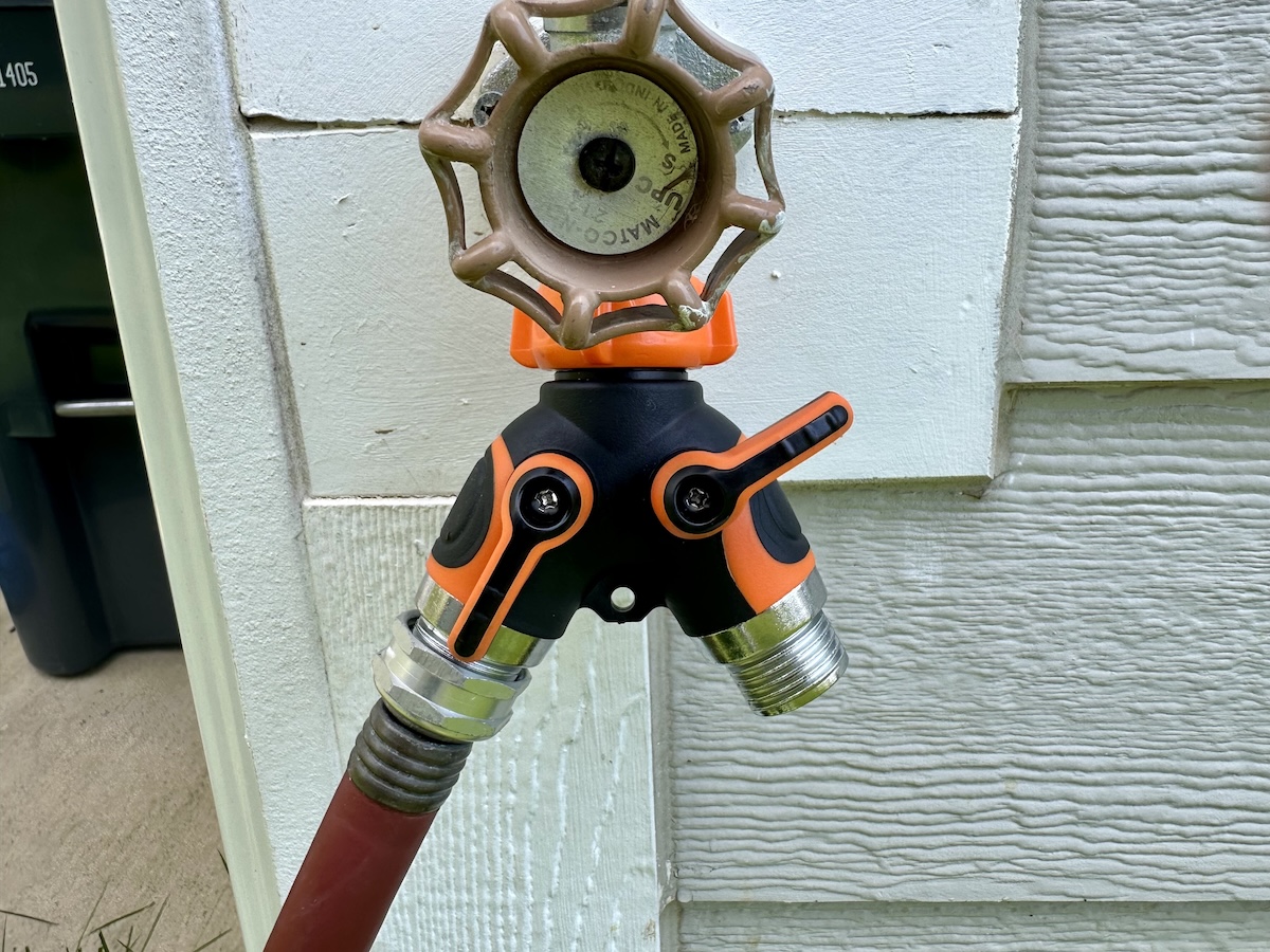 The Giraffe Tools Garden 2-Way Hose Splitter hooked up to an outdoor spigot during testing