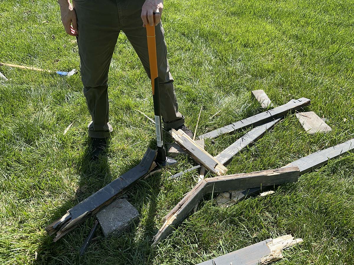 A person using one of the best sledgehammers to break apart fencing during testing
