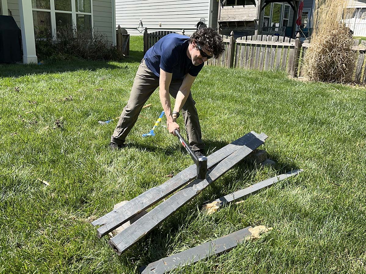 A person using one of the best sledgehammers to break apart fencing during testing