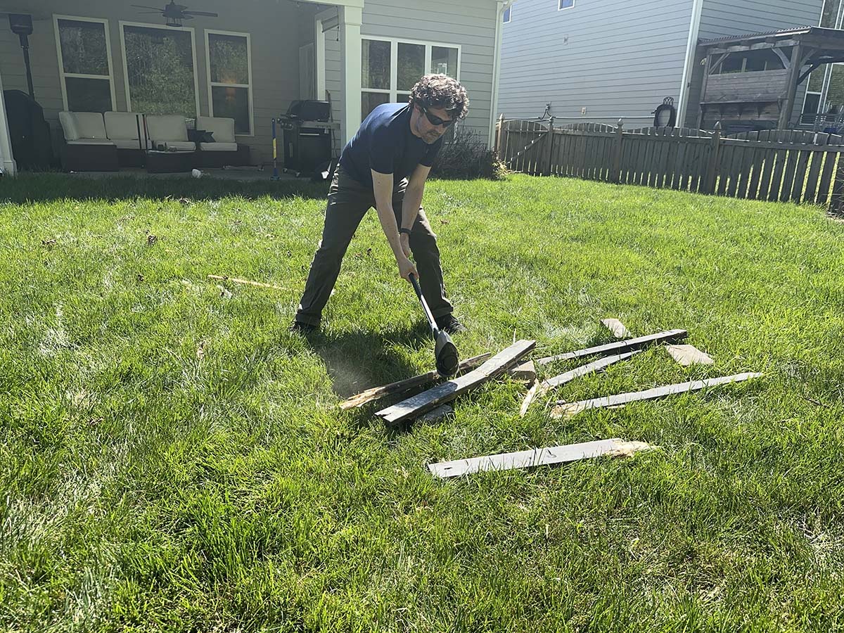 A person using one of the best sledgehammers to break apart fencing during testing