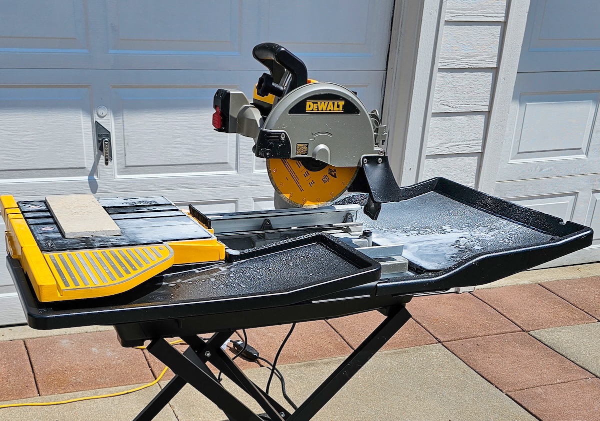 A wet saw positioned on its raised platform.