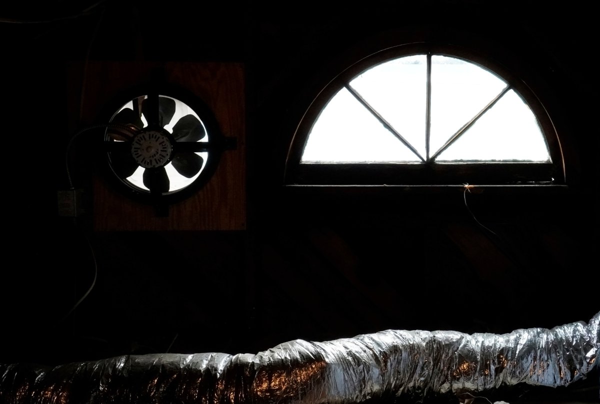 Attic fan, window and centrail air conditioning duct silhouette.