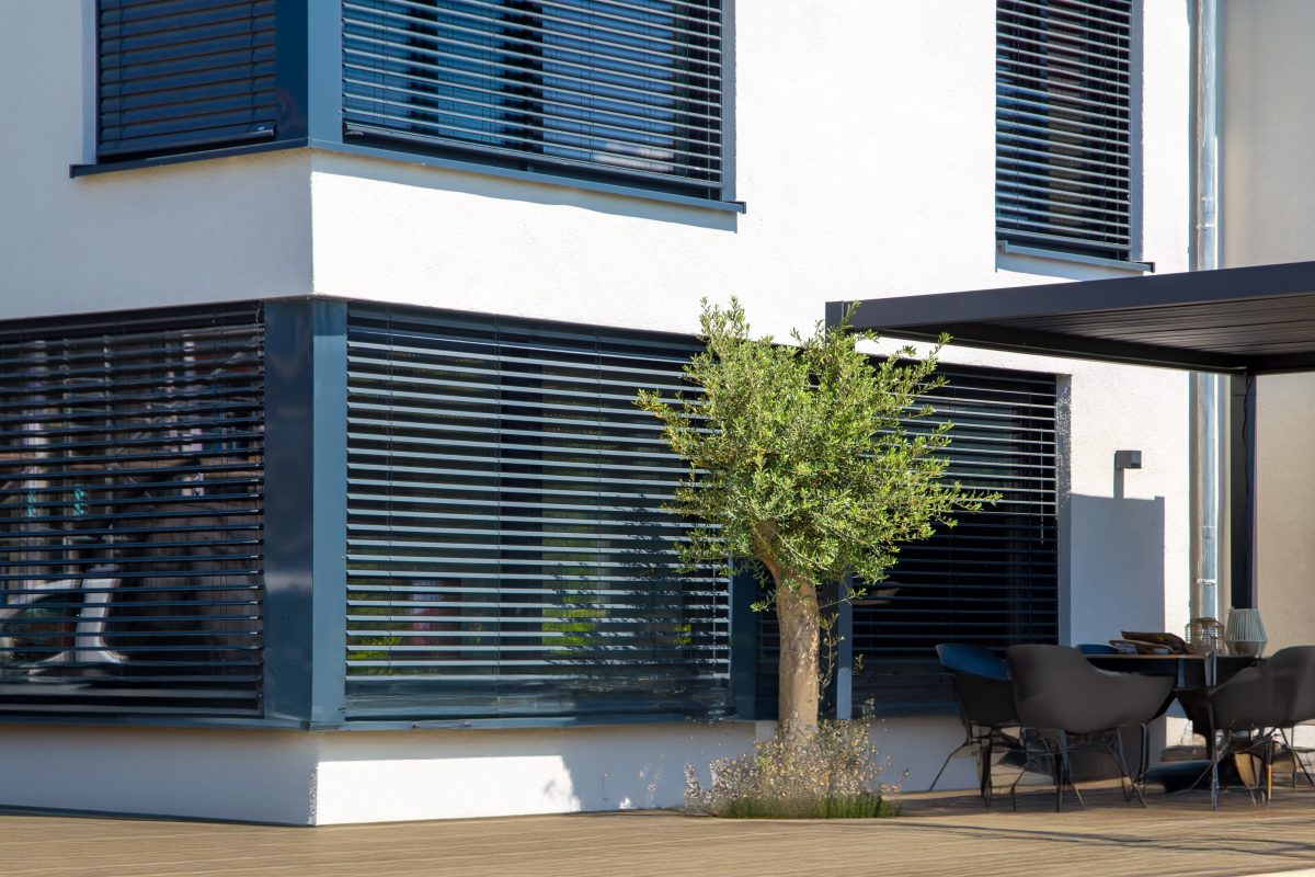 Exterior view of consistent blinds on a modern house.
