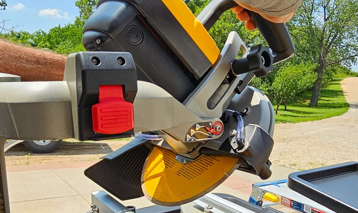 A man lowers a wet saw.
