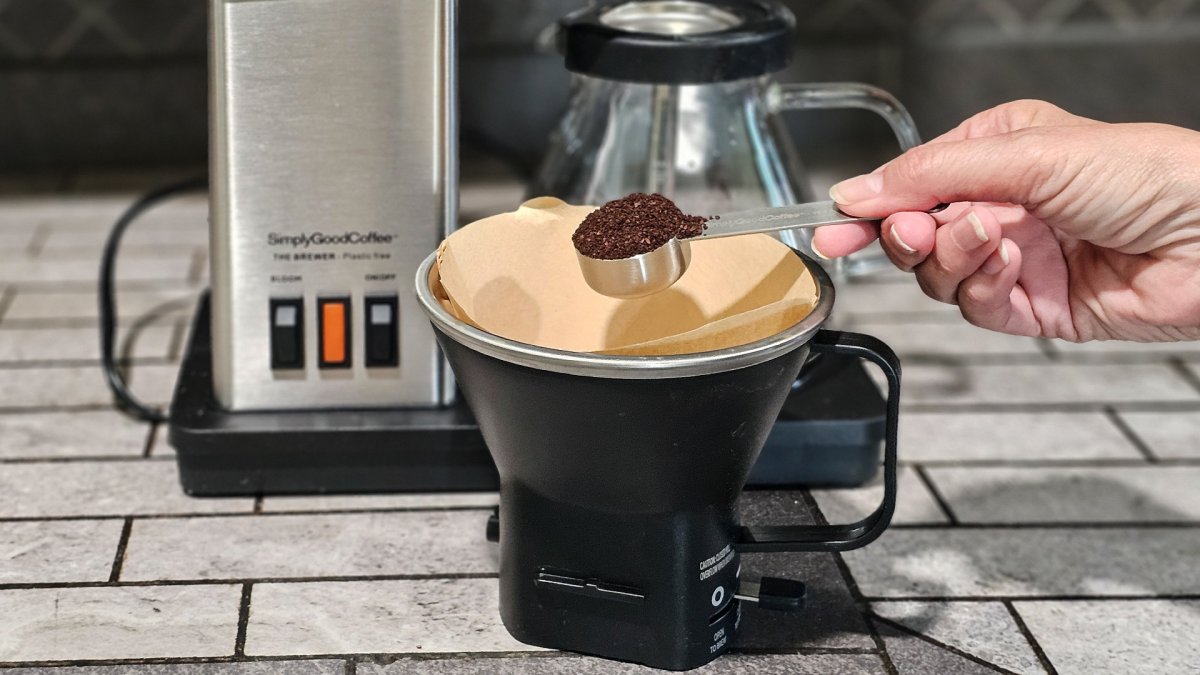 Adding ground coffee to the filter holder of the SimplyGoodCoffee brewer