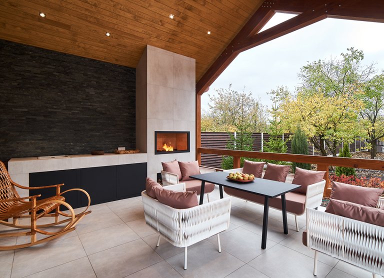 An outdoor fireplace in an outdoor living area of a custom home.