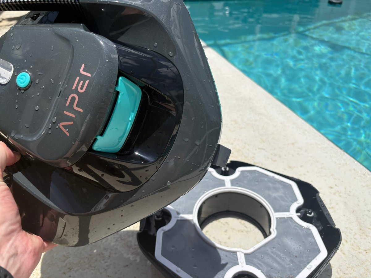 A product tester opening the Aiper Seagull SE02 to look at the filter 