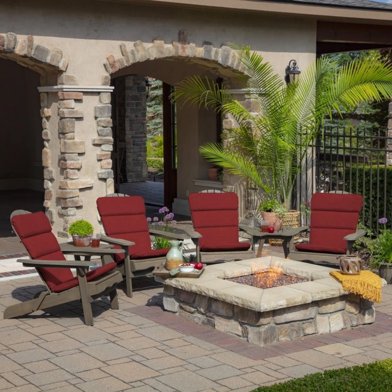 Four Bayou Breeze Outdoor Lounge Chair Cushions on Adirondack chairs next to an outdoor firepit