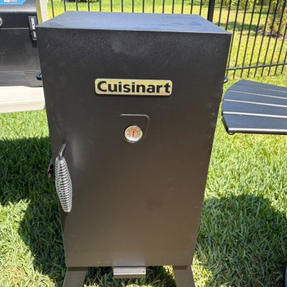 The Cuisinart Vertical Electric Smoker on a lawn before testing