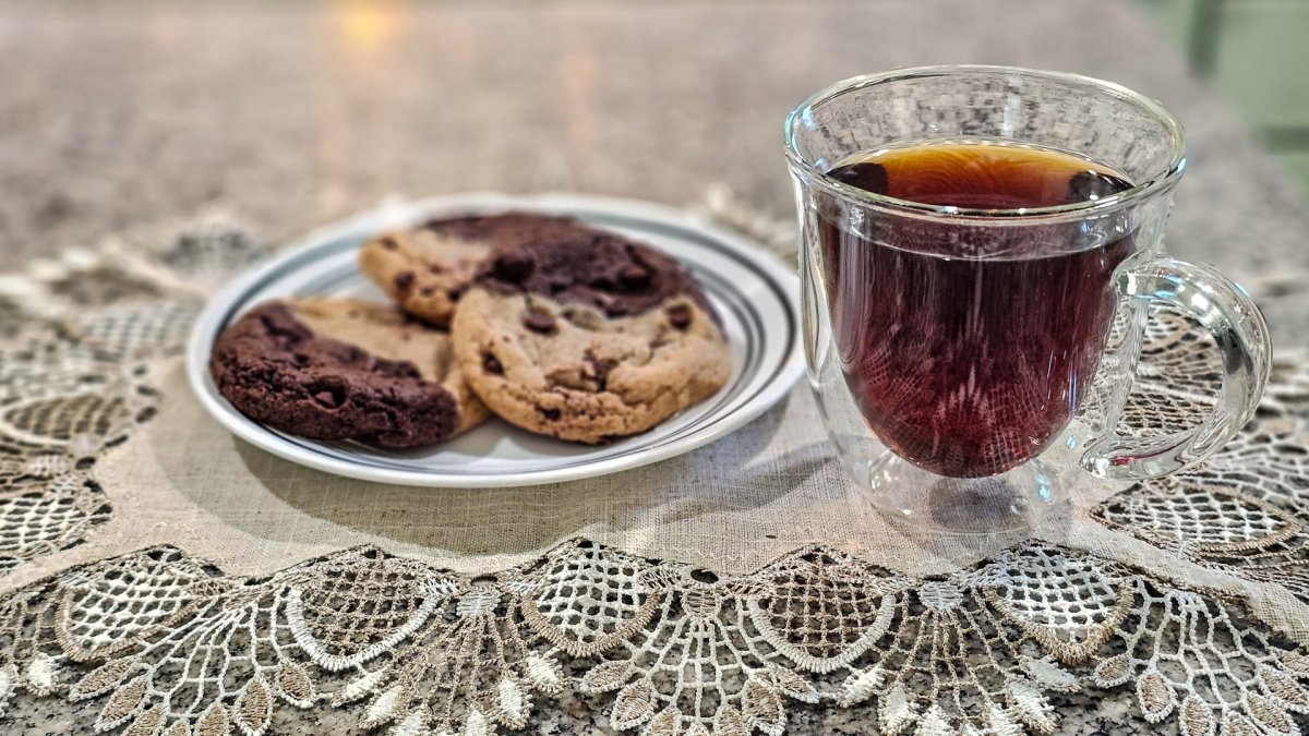 A plate of cookies next to a cup of coffee brewed with the SimplyGoodCoffee maker
