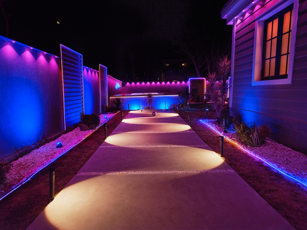 Govee permanent outdoor lights and pathway lights lighting up a backyard.