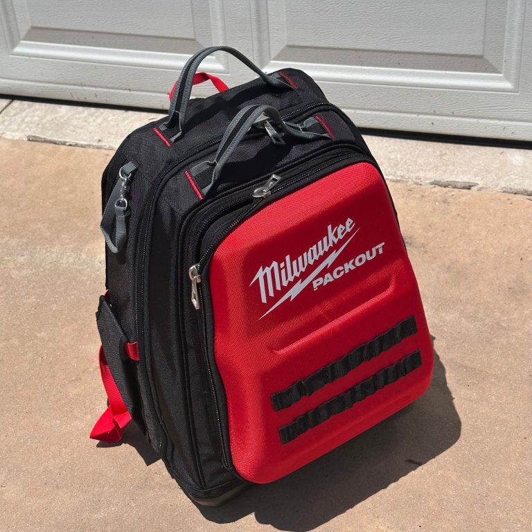 The Milwaukee Ultimate Jobsite Backpack packed and sitting in front of a garage door during testing