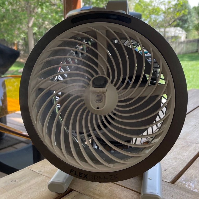 The Shark FlexBreeze HydroGo Pro Fan blowing a cooling mist across and outdoor table