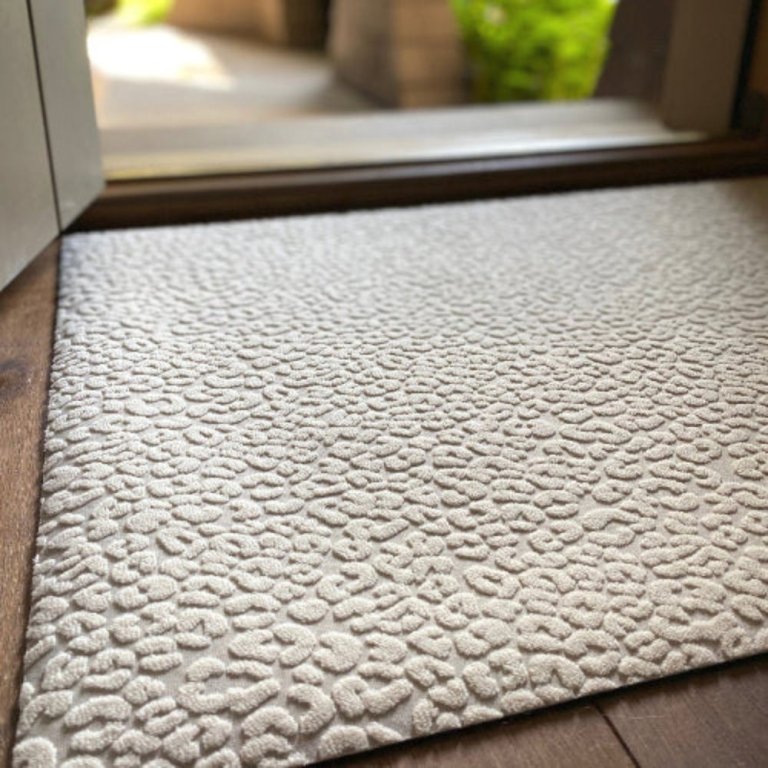 The Porte + Hall Insider Doormat in front of an open door