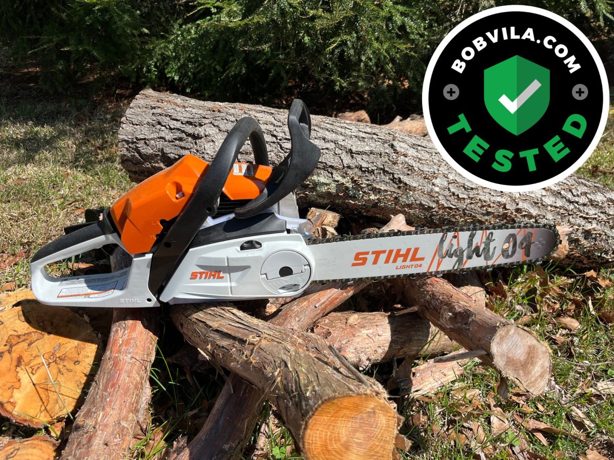 The Stihl MS 182 C-BE 16-Inch Gas Chainsaw on top of a pile of cut logs during testing