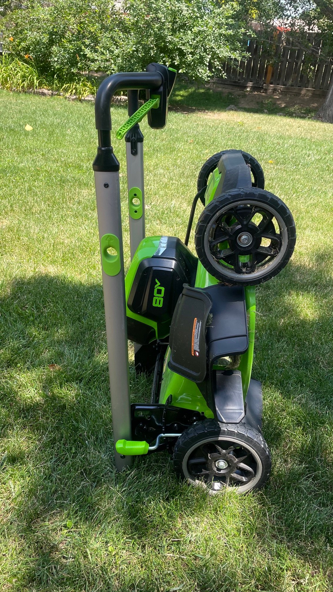 The Greenworks 80V 21-inch Cordless 4-in-1 Push Lawn Mower folded for storage
