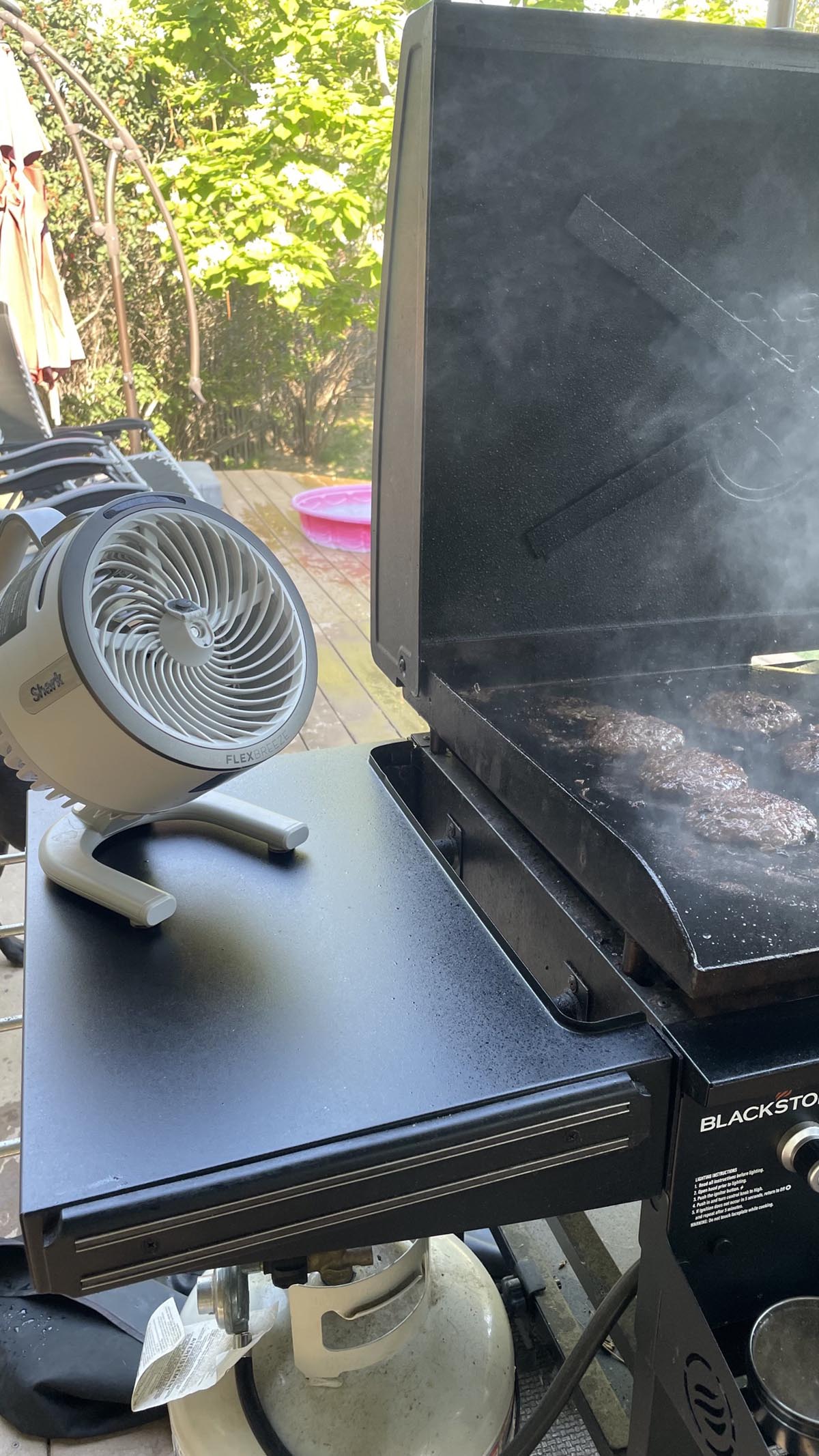 The Shark FlexBreeze HydroGo Pro Fan next to a hot griddle