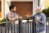 Emotional neighbours having argument near fence outdoors