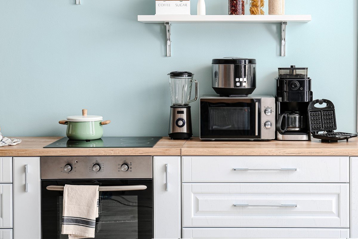 Interior of kitchen with different household appliances.
