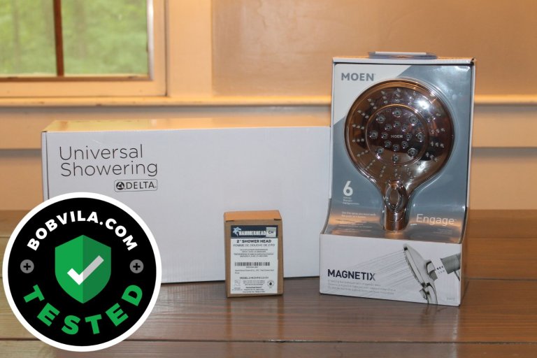 A group of the best shower heads in their packaging together on a table before testing