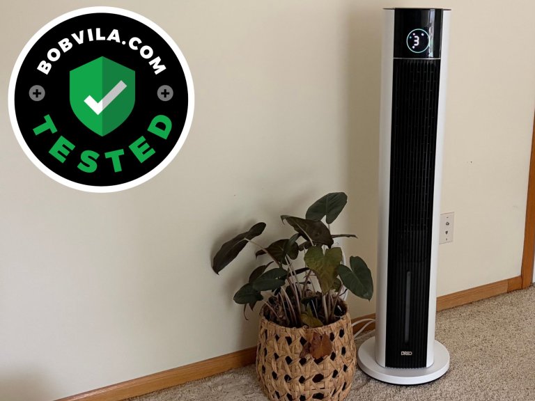 The Dreo 712S Evaporative Air Cooler in a bedroom next to a plant during testing