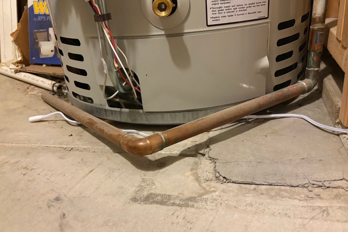Eve Water Guard Smart Water Leak Detector around water heater during testing