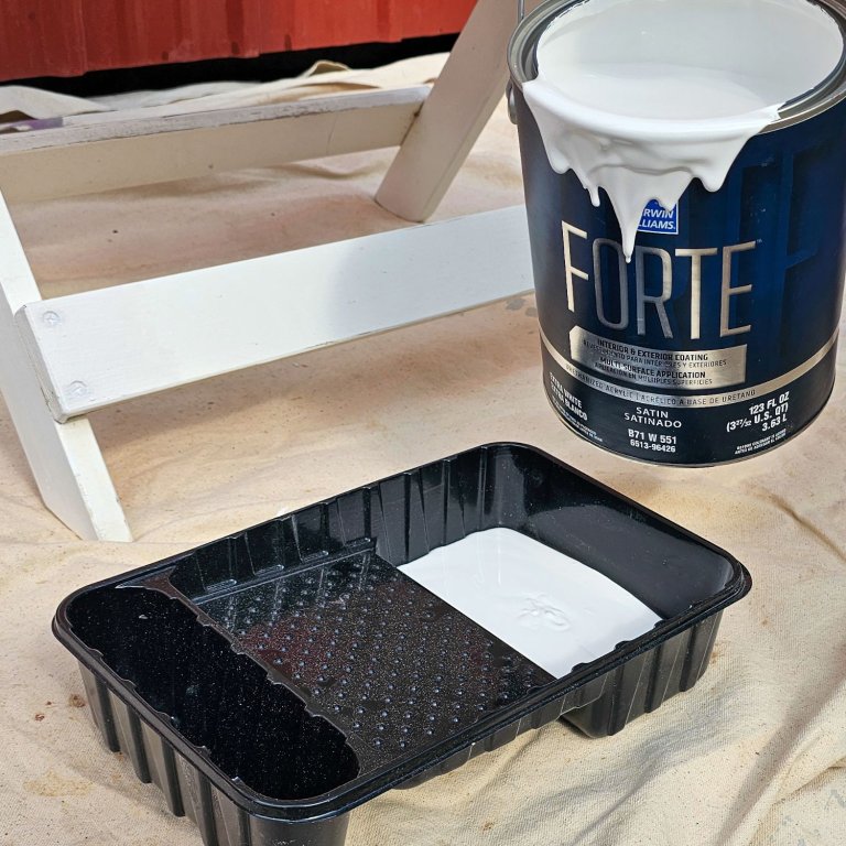 Filling roller tray with Sherwin-Williams Forte paint
