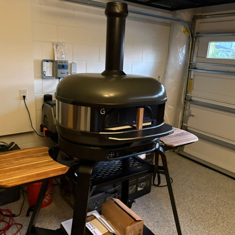 The Gozney Dome Gen 2 Propane Gas/Wood Outdoor Pizza Oven set up in a garage before testing
