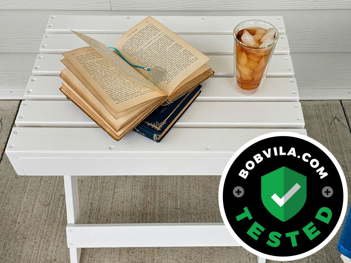 A small patio table painted with Sherwin Williams Forte Paint and holding a book and glass of tea