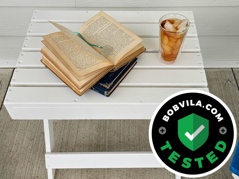 A small patio table painted with Sherwin Williams Forte Paint and holding a book and glass of tea