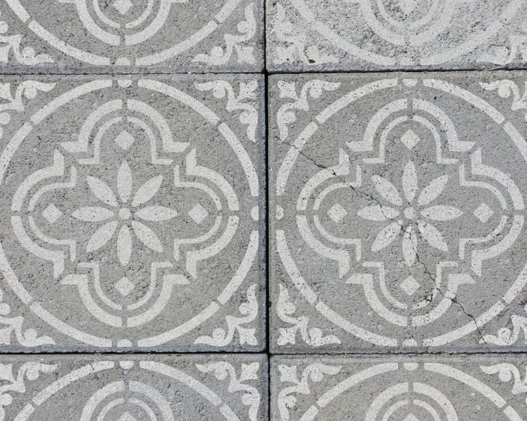Several cement blocks updated with a pattern using the Stencil Space Reusable Tile Stencil