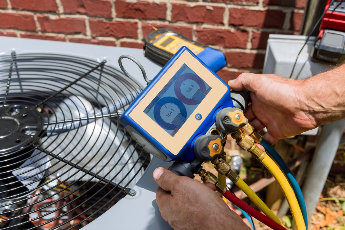 HVAC professional uses tools to check for a refrigerant leak.