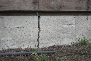 Close-up of a deep house foundation crack.