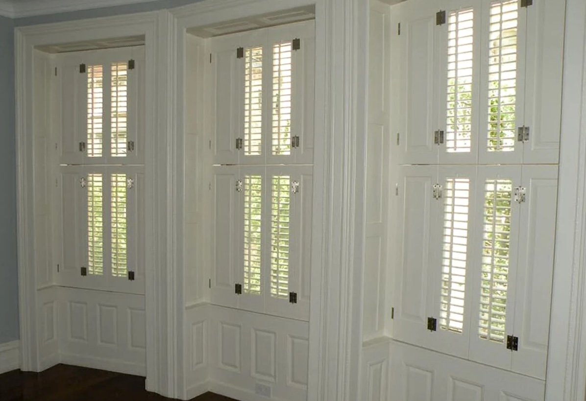 White top-to-bottom pocket shutters in a dining room.