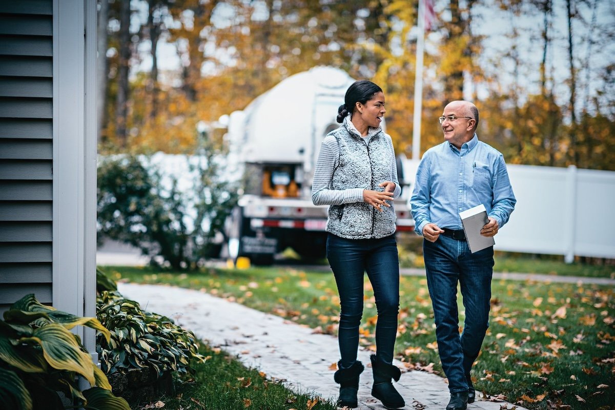 A propane expert speaking with a homeowner about a propane delivery.