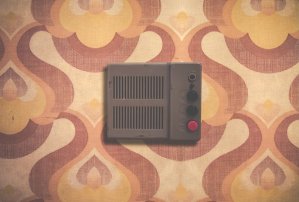 Vintage metal intercom on retro 1970s patterned wallpaper.