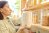 Woman holding a glass container filled with flour in her pantry