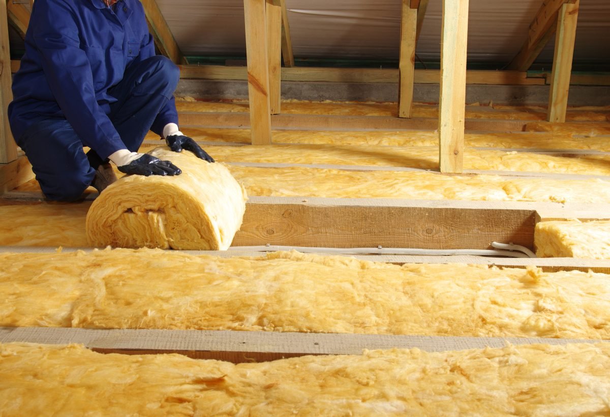 Contractor installing attic insulation.