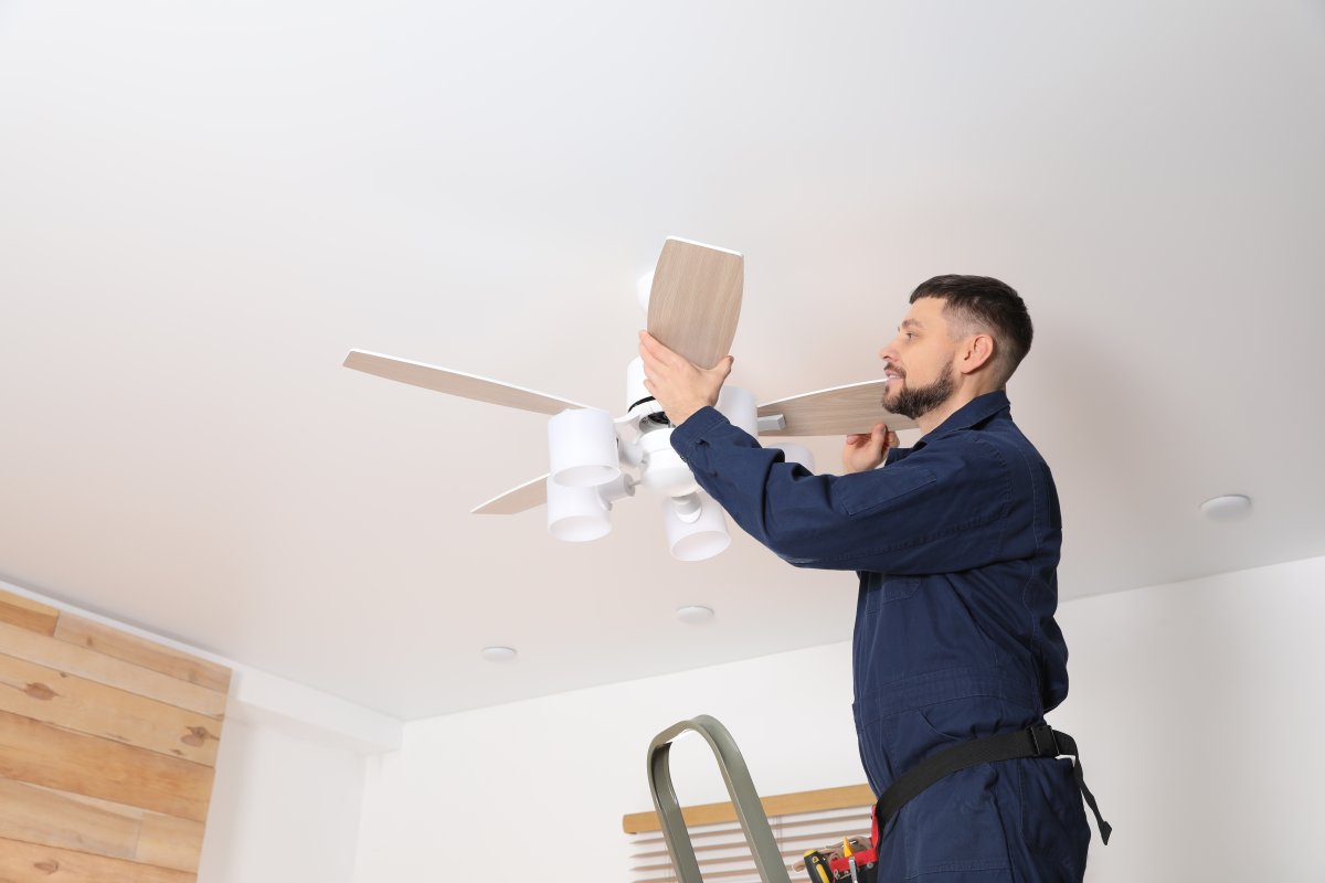 Man repairing ceiling fan