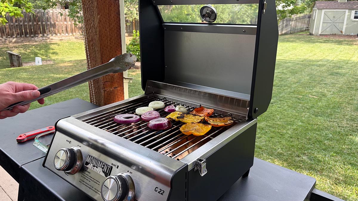 Cooking chicken and veggies on the Monument Grills G22 Stainless Tabletop Propane Grill