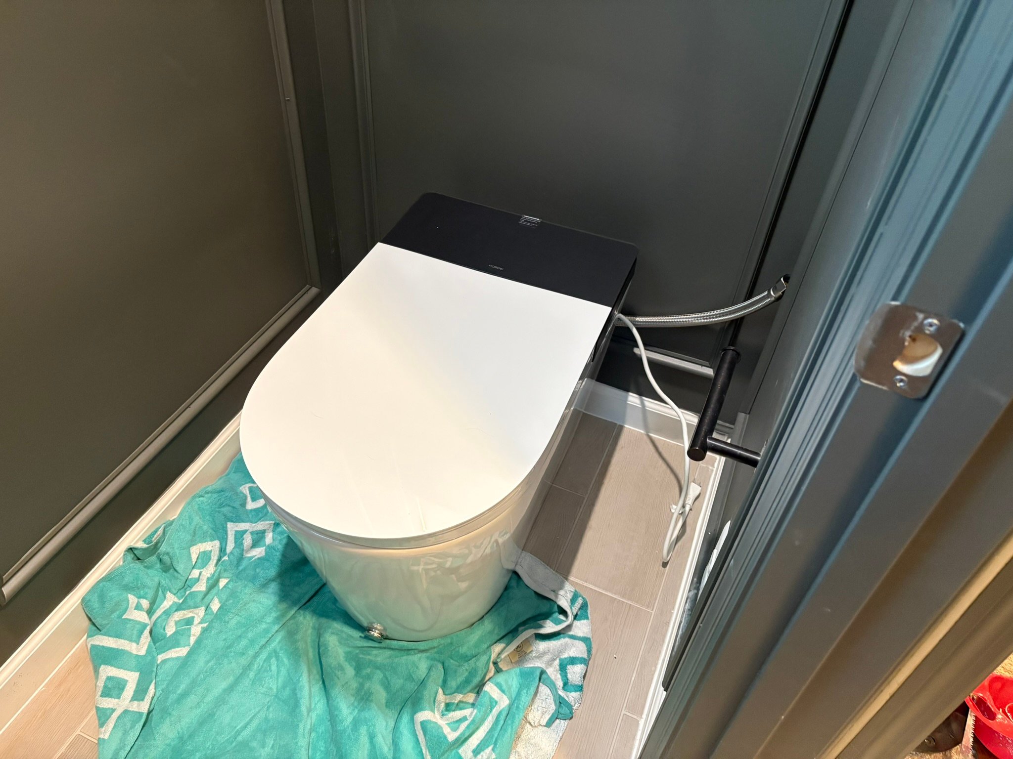 The Horow X70 Smart Toile with a towel around the base during installation