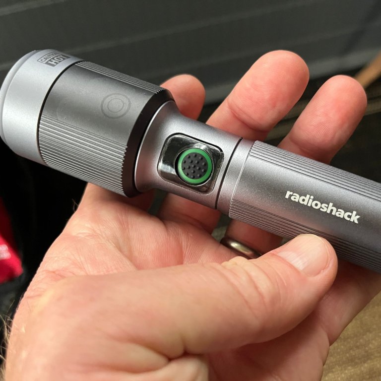 A person holding the RadioShack prepper essentials flashlight