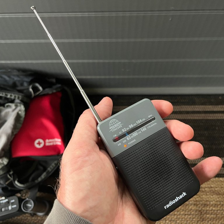 A person showing that the RadioShack prepper essentials pocket radio fits easily in the palm of their hand