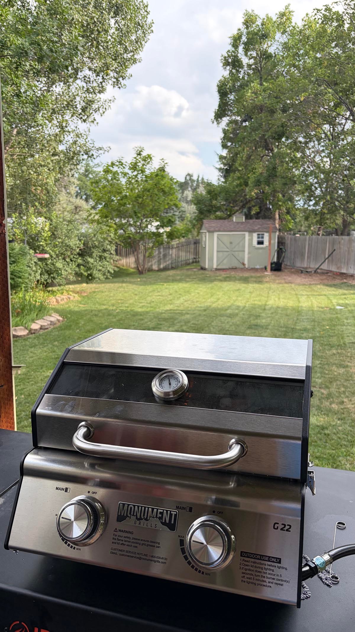 The Monument Grills G22 Stainless Tabletop Propane Grill outside during testing